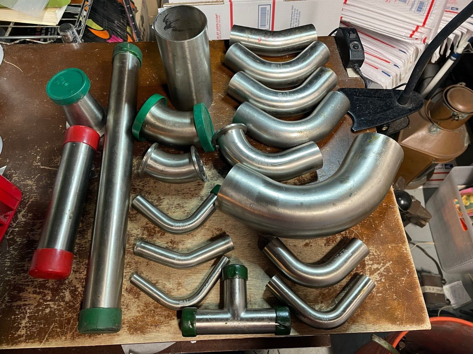 Assorted Lot of Stainless Steel Pipe Fittings, Unused Straight Elbows brewing