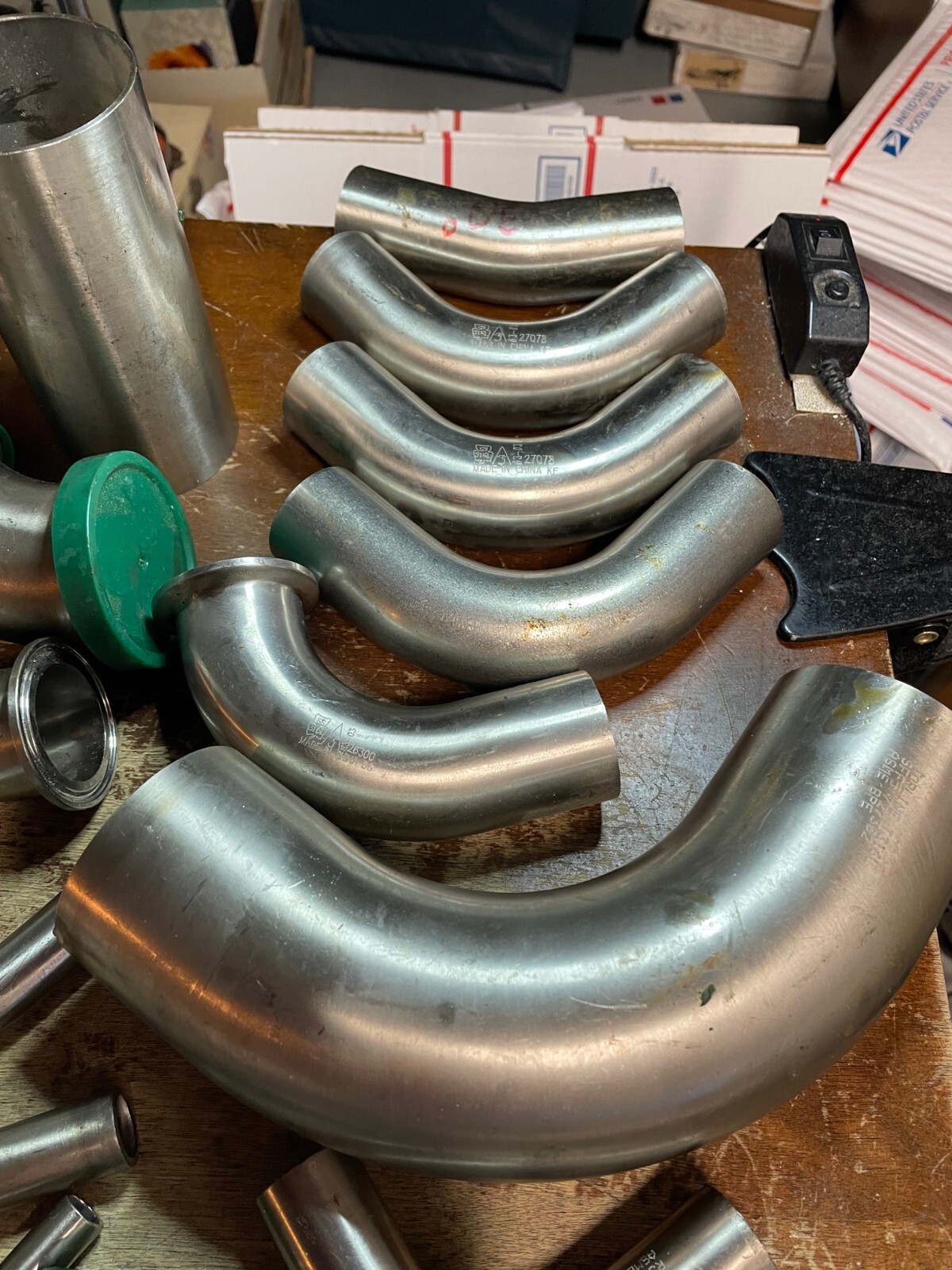 Assorted Lot of Stainless Steel Pipe Fittings, Unused Straight Elbows brewing