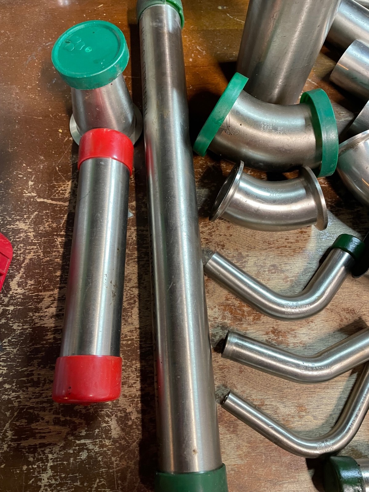 Assorted Lot of Stainless Steel Pipe Fittings, Unused Straight Elbows brewing