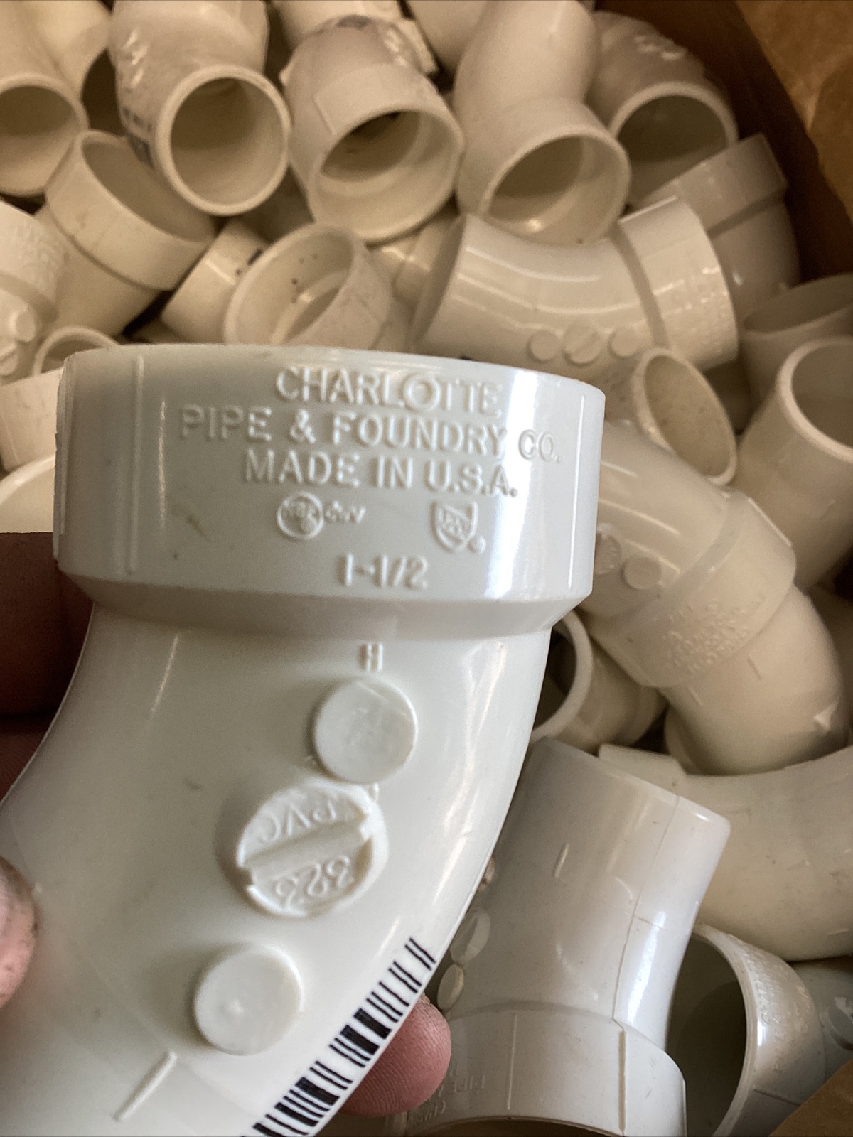 75+White 1-1/2” Charlotte #323 PVC DWV 1/8” Bent Street Elbow SPG x Hub
